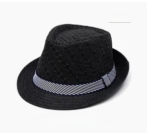 Detail of cross-woven texture and blue striped band on a black straw fedora hat