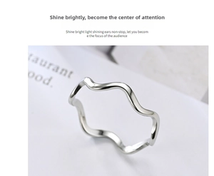 Close-up of minimalist silver wave-shaped titanium steel ring with polished finish