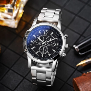 Men's stainless steel chronograph watch with black dial and silver band in business setting
