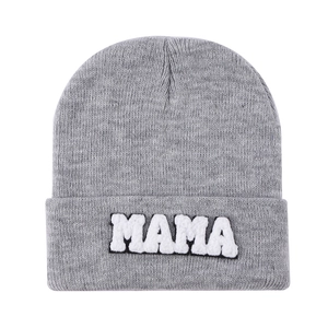 Close-up of MAMA towel embroidery on grey knit beanie with high texture detail