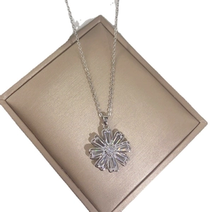 Silver flower necklace with sparkling zircons on a champagne display box