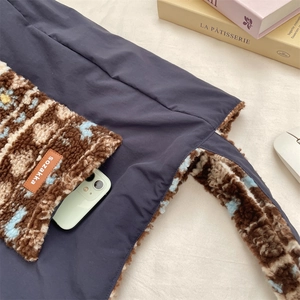 Detail of plush lamb wool pocket and canvas texture on a retro commuter shoulder bag