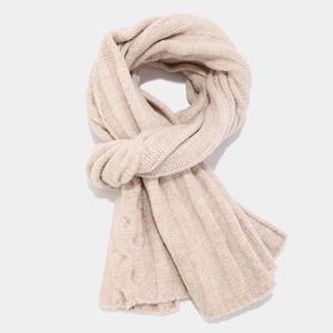 Macro detail of beige chunky cable knit scarf with thick ribbed texture for winter fashion