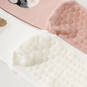 Macro detail of honeycomb silicone non-slip dots on cotton yoga five-finger socks