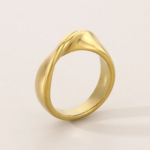 Macro shot of minimalist polished 18K gold stainless steel ring with twisted design