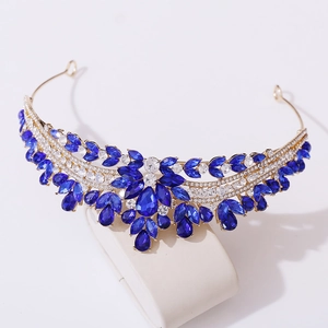 Close-up of royal blue crystals and sparkling rhinestones on an elegant gold bridal crown