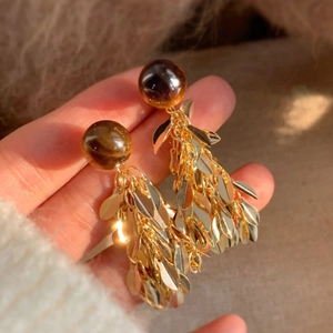 Elegant gold leaf tassel earrings with resin beads and silver needles for women