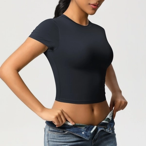Detail of slim fit black yoga crop top showing high-elastic fabric and waist curve