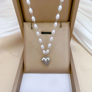Minimalist titanium steel necklace with rice pearls and heart pendant in a jewelry box