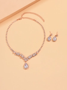 Detail of rose gold teardrop necklace and stud earrings set with sparkling zircon crystals