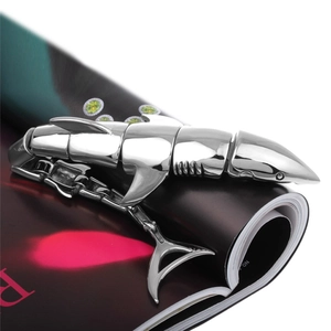 Macro detail of silver shark link bracelet with mechanical joints on magazine