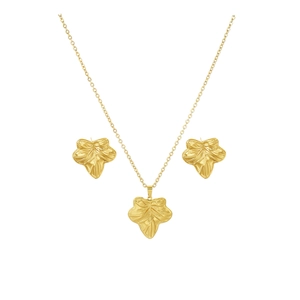 Detail of gold leaf flower jewelry set featuring embossed texture on white background