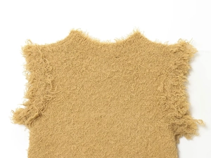 Detailed macro view of the fluffy faux fur texture and neckline of the khaki knitted top