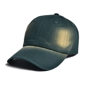 Detail of vintage faded green cotton baseball cap with retro washed finish texture
