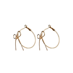 Minimalist gold bow hoop earrings for women with polished metal finish on white background