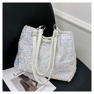 Macro detail of high-capacity tote with iridescent sequins and white shoulder straps