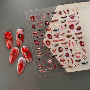 Halloween nail stickers with bloody lips and eyeballs for spooky DIY manicure designs