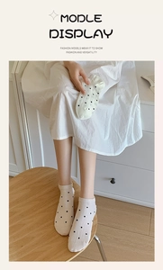 Close-up of white polka dot cotton low-cut socks showing breathable mesh and soft texture
