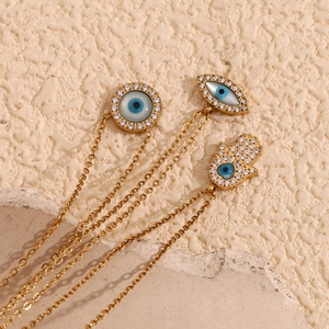 Détail macro de pendentifs Main de Fatma et Mauvais Œil plaqués or 18 carats sur pierre