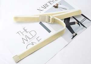 Detail of striped canvas belt with matte double D-ring buckle on fashion magazines