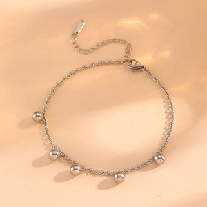 Detail of silver stainless steel anklet with five beads and S.STEEL hallmark engraving