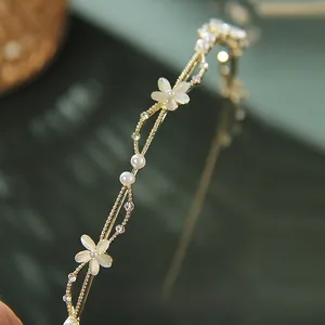 Detail of French leaf headband with cat eye stone flowers and pearls on gold frame