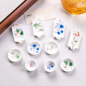 Miniature blue and white porcelain plates with traditional fish and floral pattern