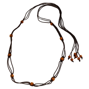 Detail of bohemian waist chain with dark brown cotton cords and polished wooden beads