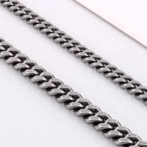 Close-up of vintage grey stainless steel Cuban links with a distressed metallic finish