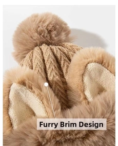 Detail of plush brim and high-density cable knit texture on camel winter fox ear hat