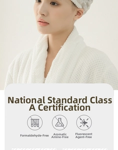 Close-up of white waffle texture hair towel with A-class safety certification details