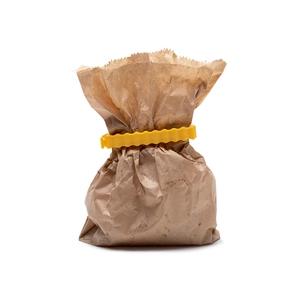 Close-up of yellow sealing clip on kraft paper bag for creative food preservation