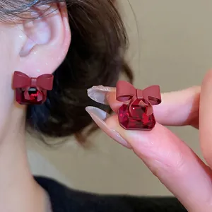 Elegant red bow crystal earrings featuring square cut rubies in gold plating