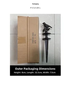 Detail of vintage cast iron bird garden stake next to its compact packaging box
