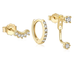 Macro shot of gold S925 sterling silver evil eye earrings set with diamond pavé accents