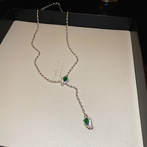 Luxe silver snake chain Y-necklace featuring emerald green teardrop crystals and small zircons