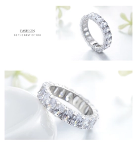 Macro view of full eternity band with oval-cut white stones in sterling silver