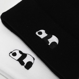 Black and white knit beanies featuring cute panda embroidery in a cozy ribbed texture