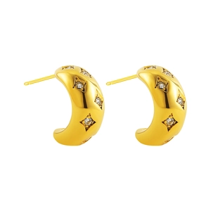 Close-up of 18K gold-plated C-shaped hoop earrings with sparkling star-set zircon details
