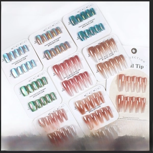 Detail view of assorted metallic chrome press-on nails in aurora green and blue finishes