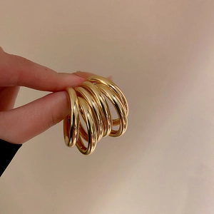 Detaillierte Nahaufnahme der hochglanzpolierten klobigen Goldringe, in der Hand gehalten