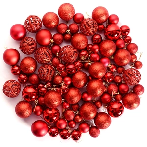 Detailed view of red Christmas ball set with glitter, matte, and cutout patterns