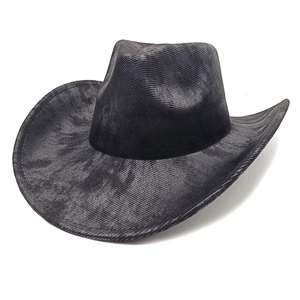 Detail of vintage black cowboy hat with textured corduroy fabric and wide curved brim