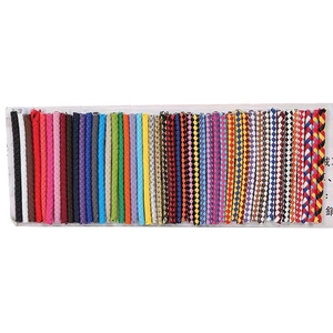 Close-up of colorful braided leather keychains in various solid and patterned designs