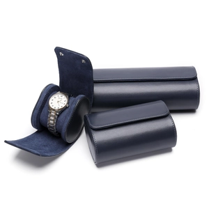 Detail of premium navy blue leather watch roll with velvet lining and metal snap buttons