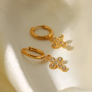 Detail of 18K gold-plated titanium earrings with sparkling crystal cross pendants