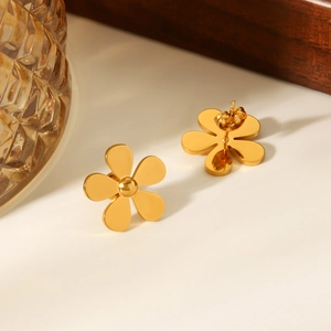 Detailed view of 18k gold-plated five-petal daisy stud earrings on an elegant white surface