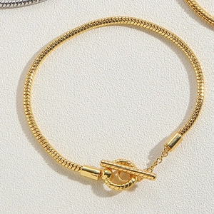 Golden snake chain bracelet with textured toggle clasp and minimalist metal finish