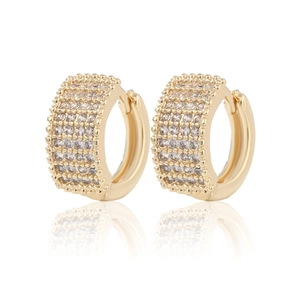 Detailed macro view of gold-plated huggie earrings with four rows of sparkling cubic zirconia