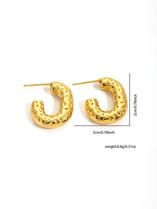 Macro view of gold stainless steel chunky hoop earrings with textured hammered finish